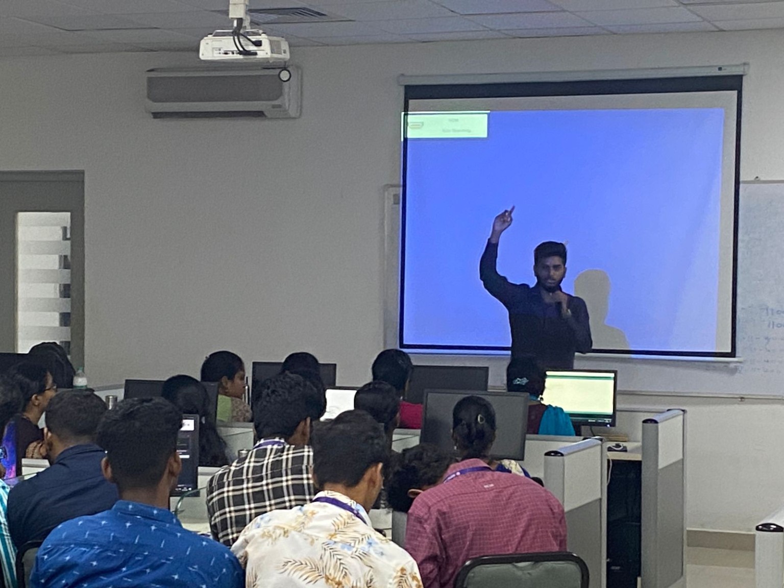 Codexaon instructor presenting to learners seated at computers